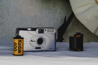 Kodak camera and roll of film with black and yello Kodak brand.