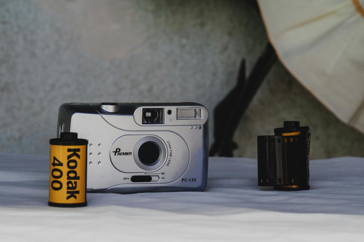 Kodak camera and roll of film with black and yello Kodak brand.