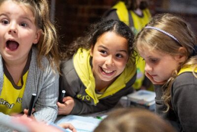 Excited Brownies at a table working on something creative.