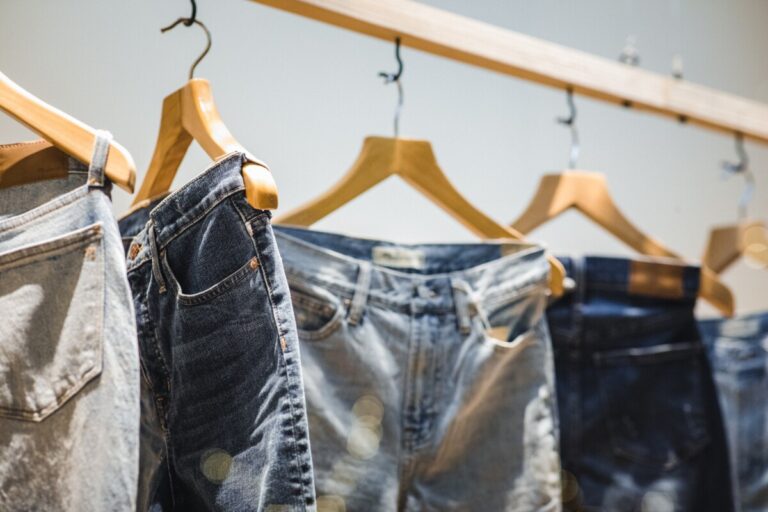 Pairs of jeans hanging on a clothing rail. Photo: Unsplash