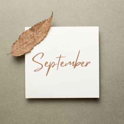 September, written on square paper with a dried leaf fallen on it in the top left.