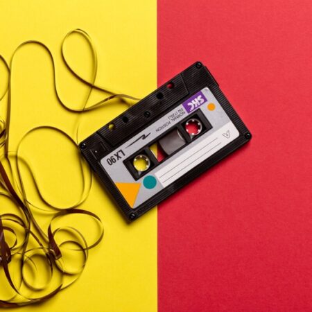Tape cassette unspooled on yellow and red background - image: pexels.com