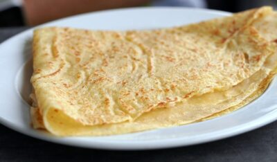 Pancake, folded on a white plate.