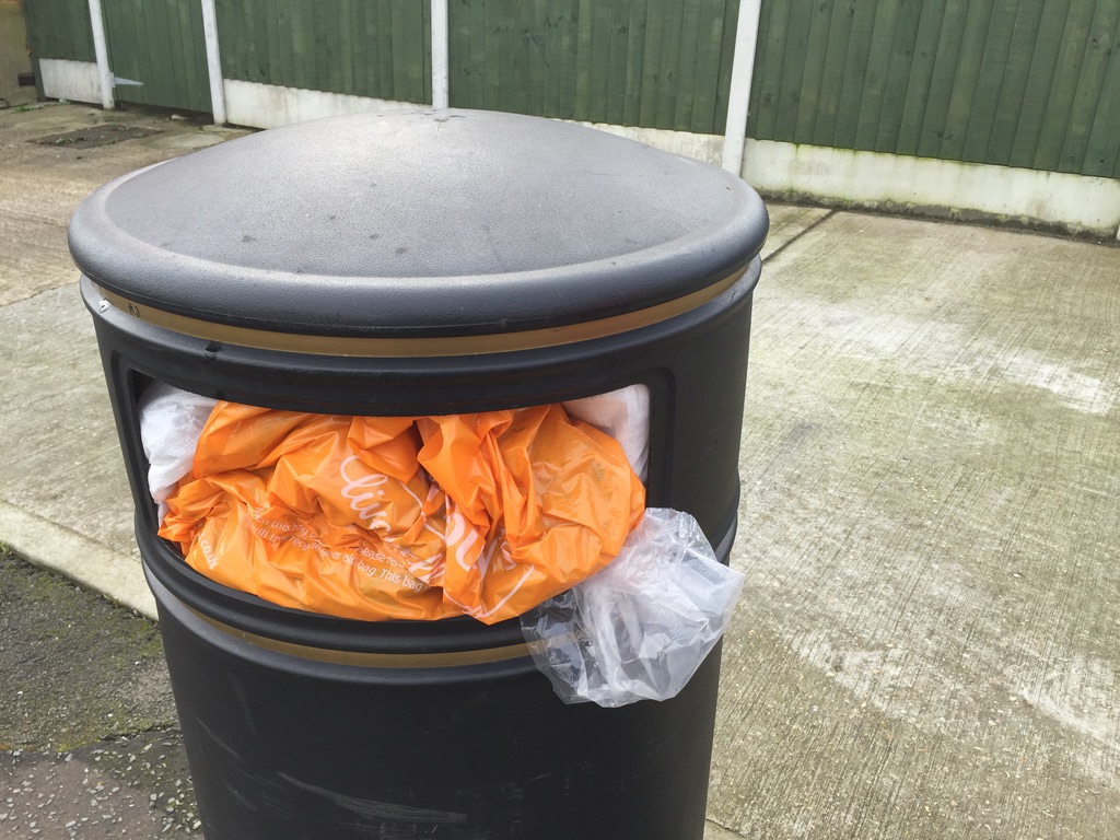 Unwanted plastic bags stuffed into a rubbish bin.