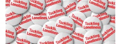 Red and white 'tackling loneliness' buttons. Image: British Red Cross