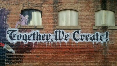 Together We Create - sign painted on a wall - Unsplash