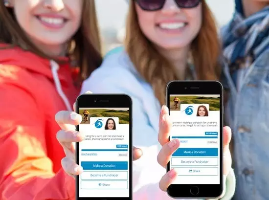 Group of smiling people showing fundraising campaigns on their mobile phone screens