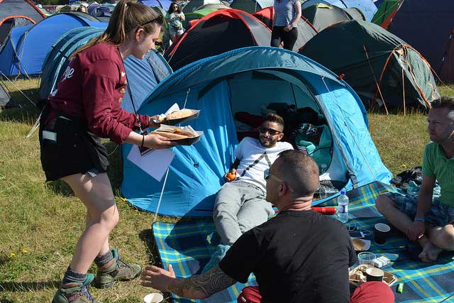 A Charity Concierge volunteer brings lunch at Latitude 2015.