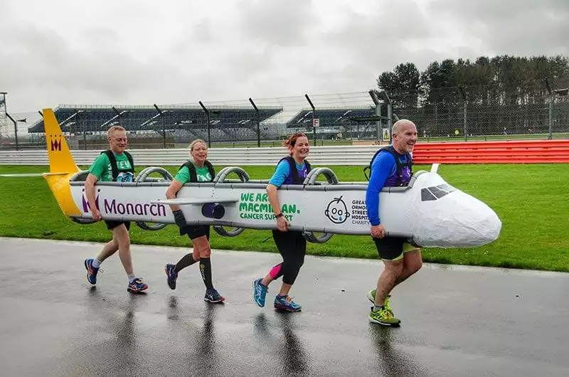 Monarch Airlines staff run for Macmillan Cancer Support in an aircraft 'costume'