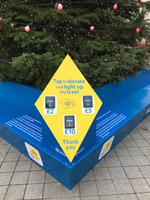 Tap to donate at #LightUpXmas Marie Curie Christmas tree on London's Southbank