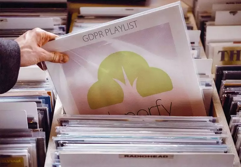 A Donorfy logo on a vinyl record being selected in a store