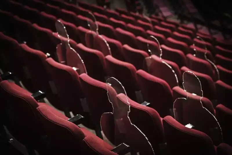 There But Not There silhouettes in theatre seats