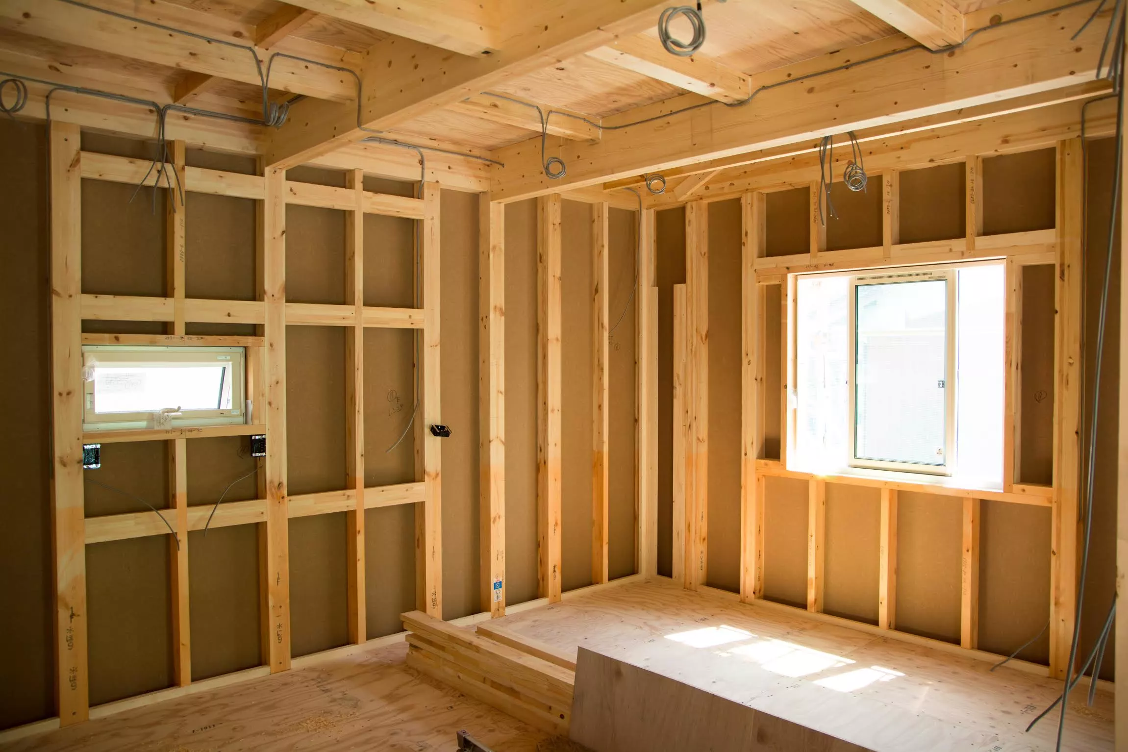 Interior of half-built wooden building. Image: Shutterstock via Giles Pegram