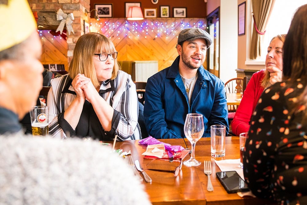 Adam Thomas joins in Brewing Good Cheer at a pub table