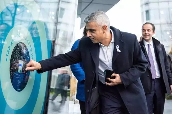 Mayor of London Sayed Khan makes a contactless donation. Photo: Tap London