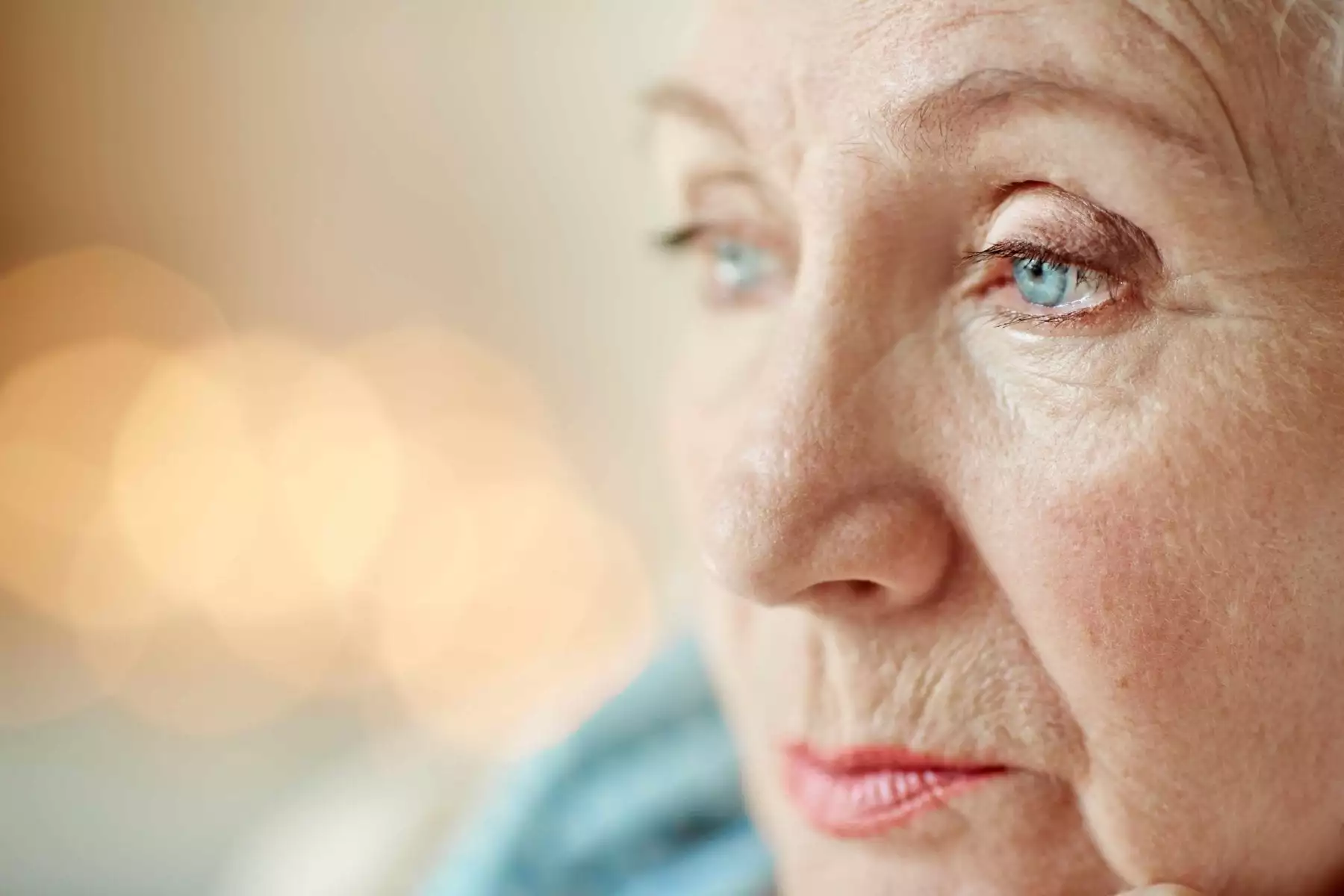 Close-up of older woman with blue eyes in contemplative mood