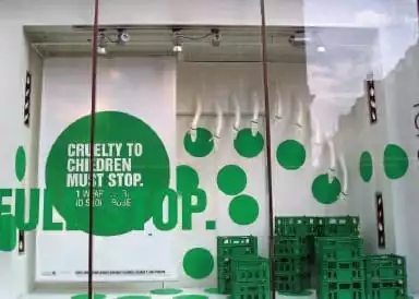 Topshop window with NSPCC Full Stop campaign display