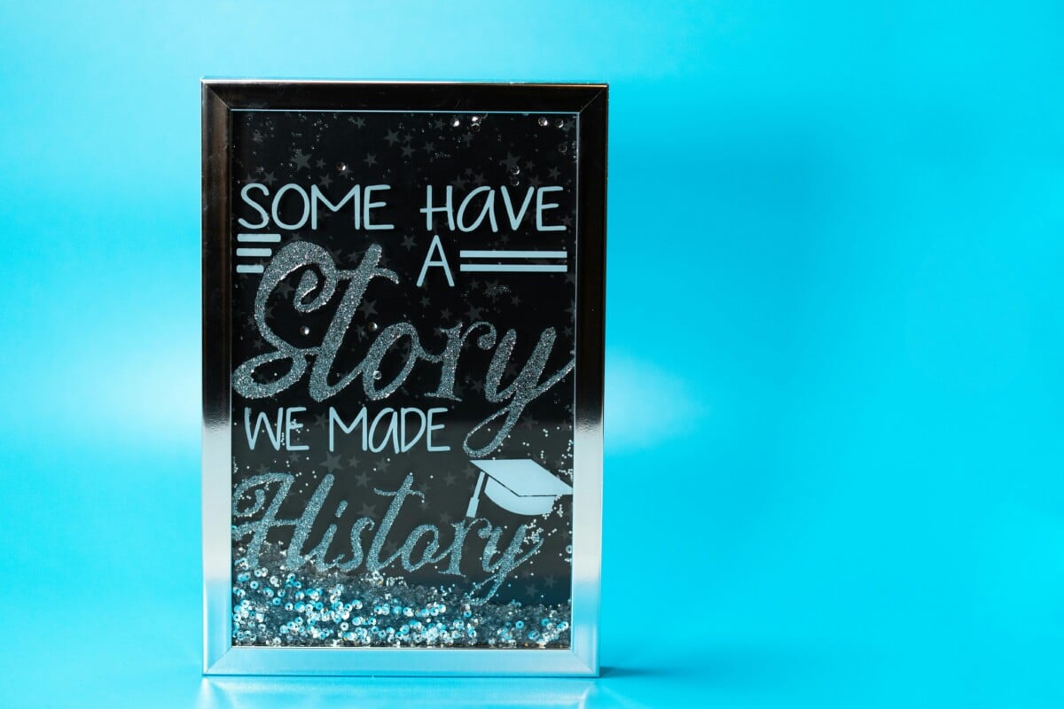 Some have a story: we made history. Poster in a silver frame against Twitter blue background.