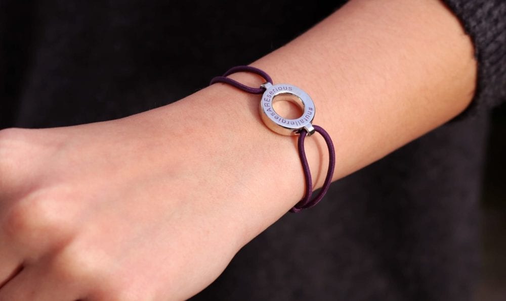 Amy May Trust wristband worn on a womans wrist