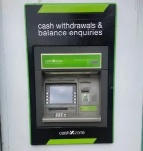 Photo of ATM, with sign 'cash withdrawals & balance enquiries'