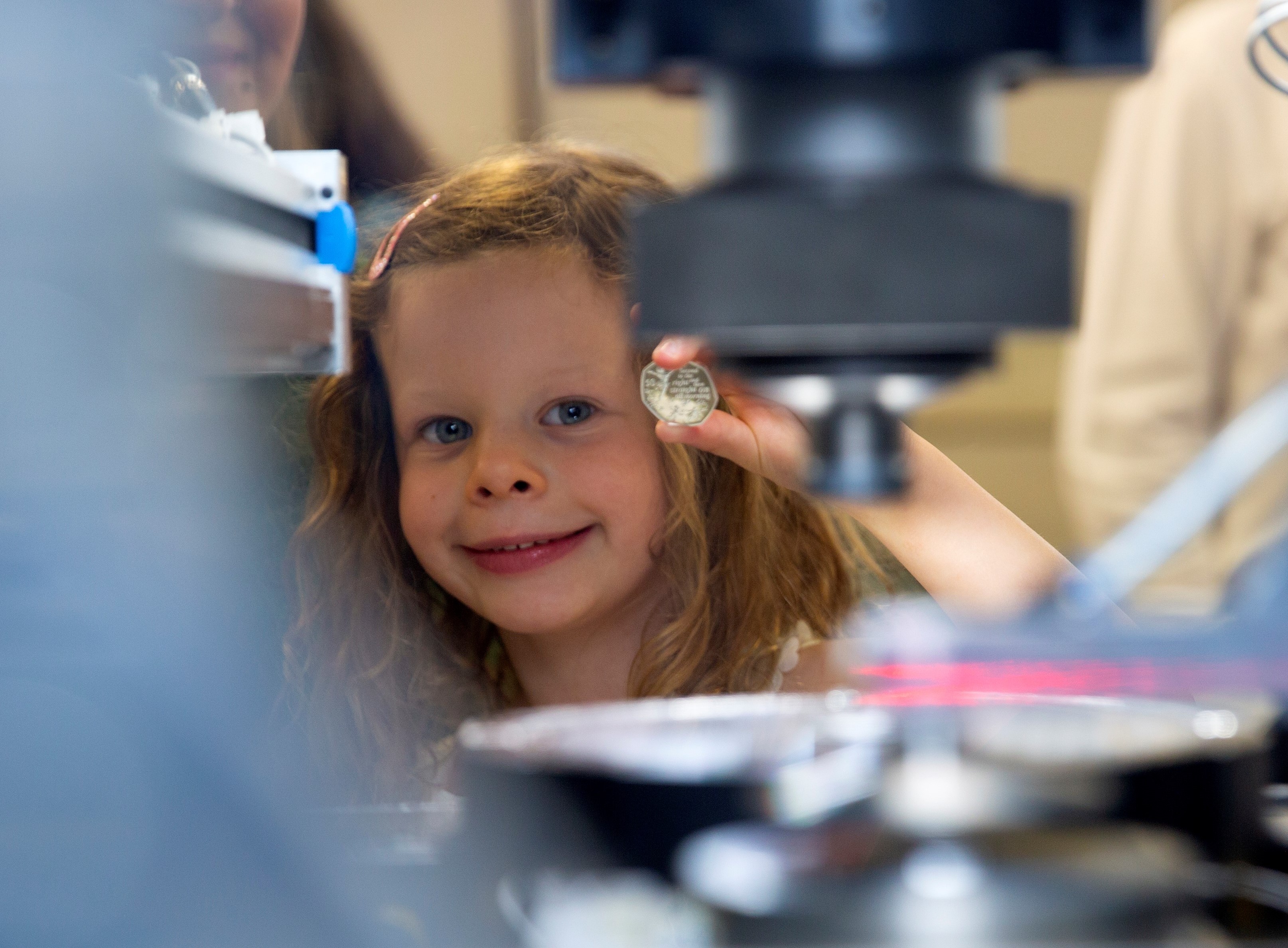 GOSH patient Olivia presents the first Peter Pan 50p coin.