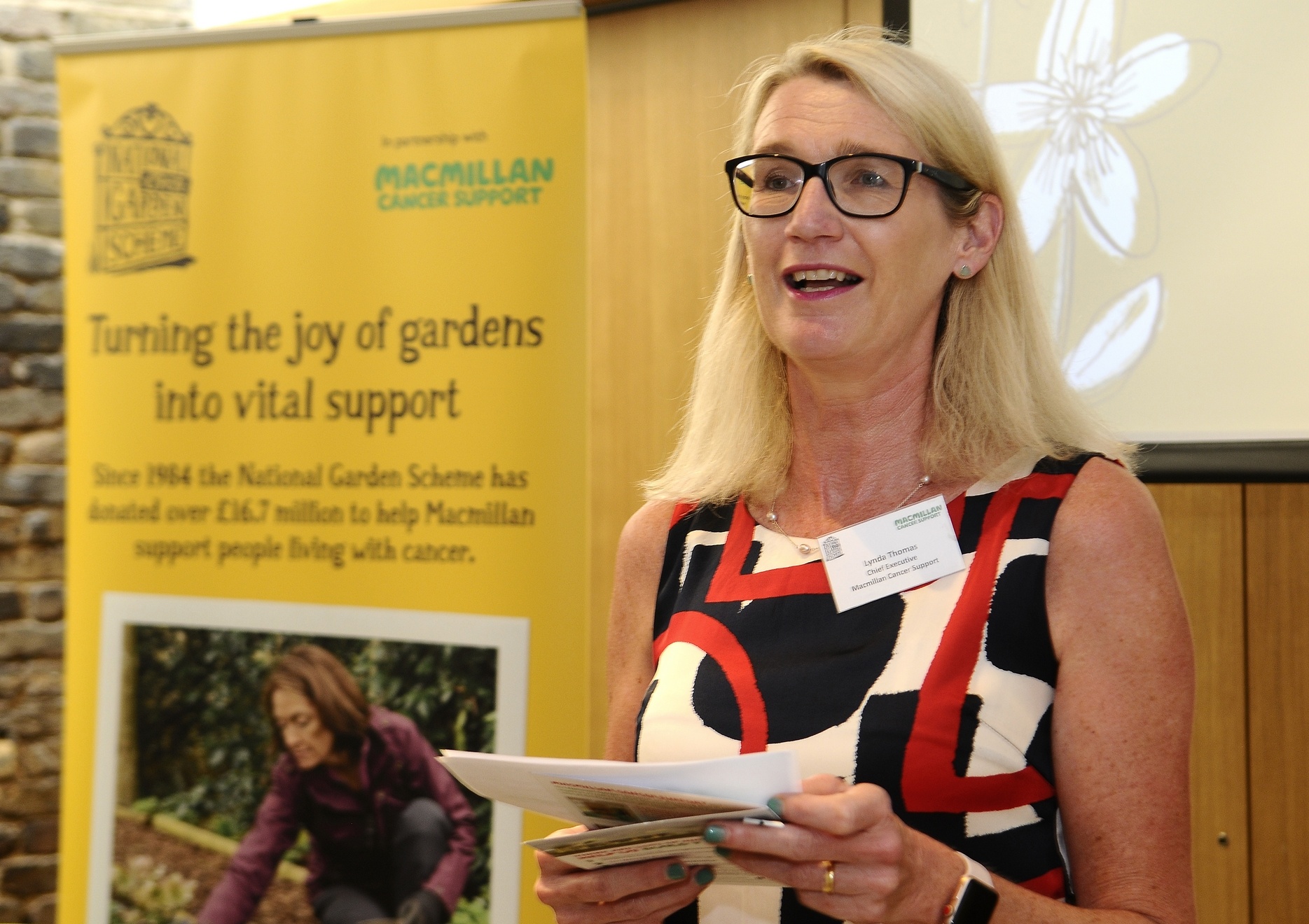 Lynda Thomas, CEO, celebrating 35 years of Macmillan Cancer Support and the National Gardens Scheme's partnership