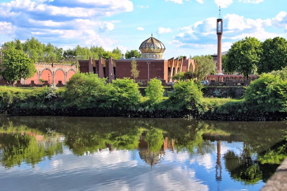 Mosque amongst trees and a lake