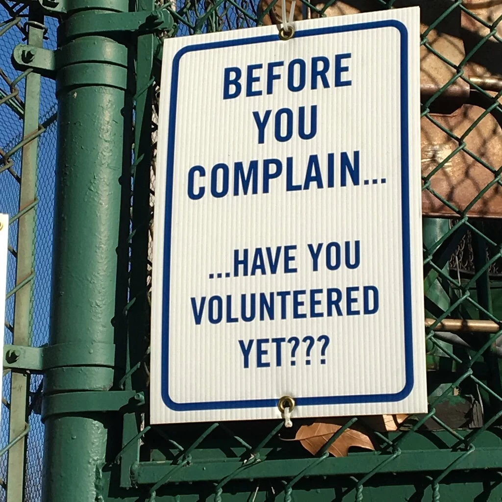 Street sign saying 'Before you complain... have you volunteered yet?'
