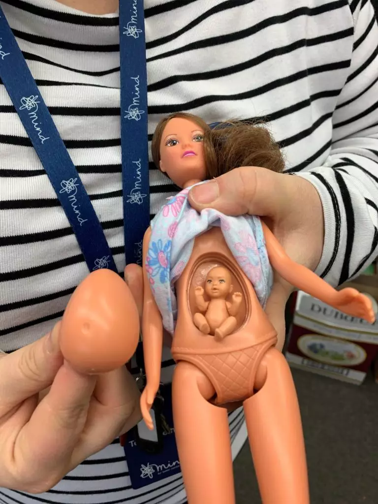 Pregnant doll held by Mind charity shop manager at Alnwick