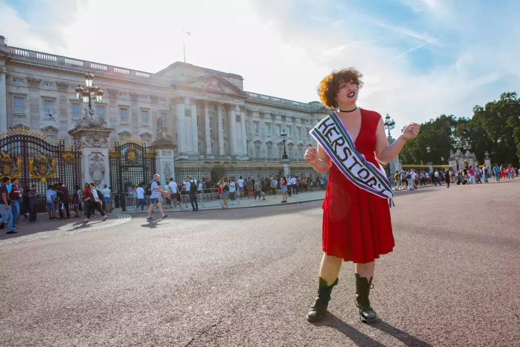 Ali Wright delivers child.org Feminist Walking Tour outside Buckingham Palace