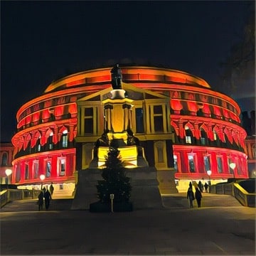 Royal Albert Hall illuminated externally with red lights.