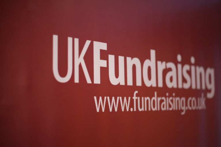 UK Fundraising logo on a pop-up stand