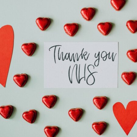 Written 'thank you NHS' message amongst red love hearts - photo: Pexels.com