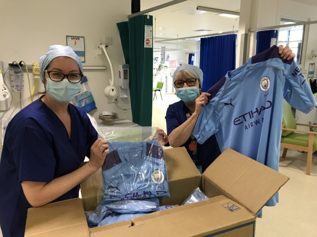 Boxes of hospital gowns for children made from Manchester City shirts