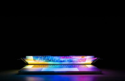 A brightly coloured laptop screen reflecting on the keyboard by Joshua Woroniecki from Pixabay