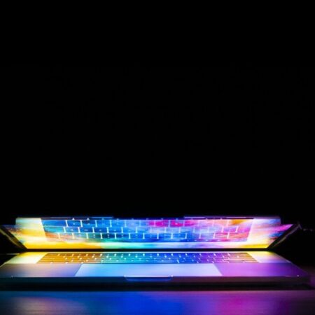 A brightly coloured laptop screen reflecting on the keyboard by Joshua Woroniecki from Pixabay