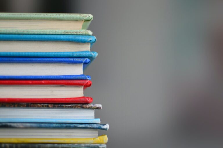 Colourful stack of books by Kimberly Farmer on Unsplash
