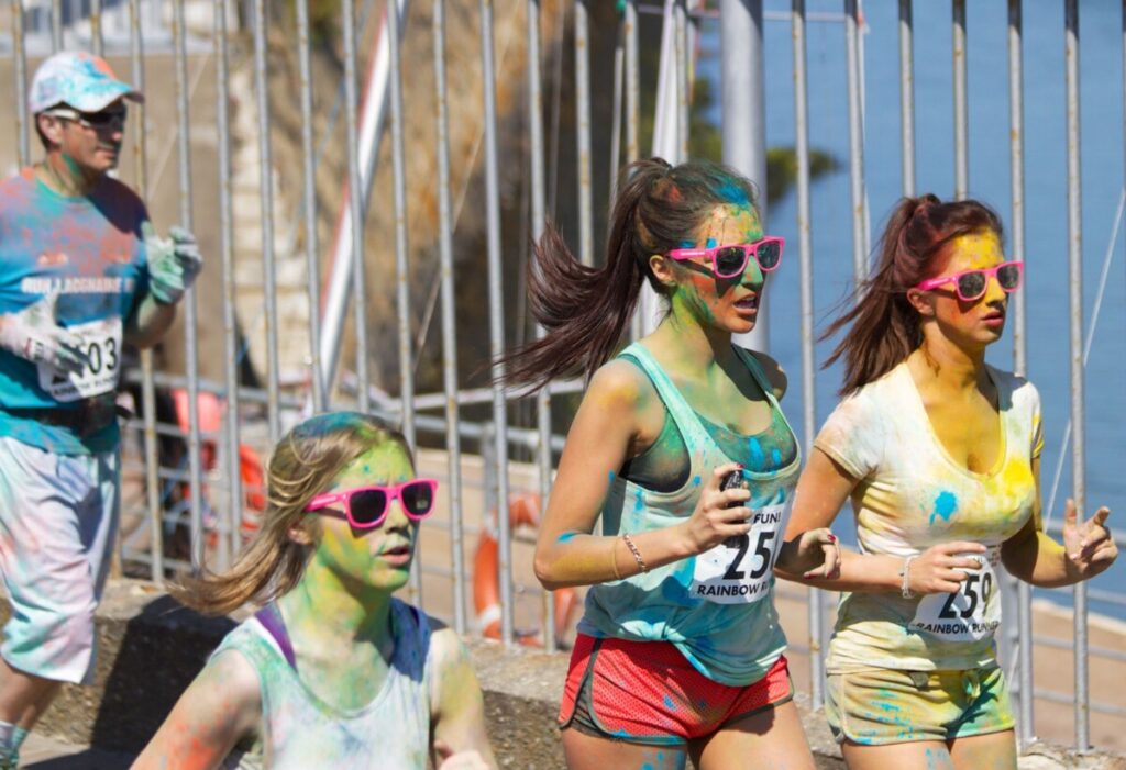 A colour run event with women running covered in paint stains by Picography on Pexels