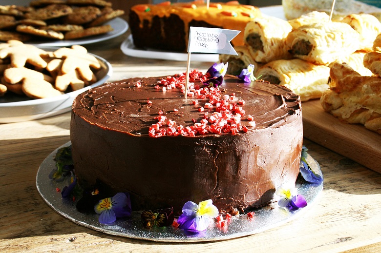 A big chocolate cake decorated with flowers