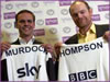 Murdoch and Thompson with their names on football shirts