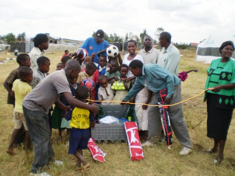 Crowd explore a teachers box, in Kenya