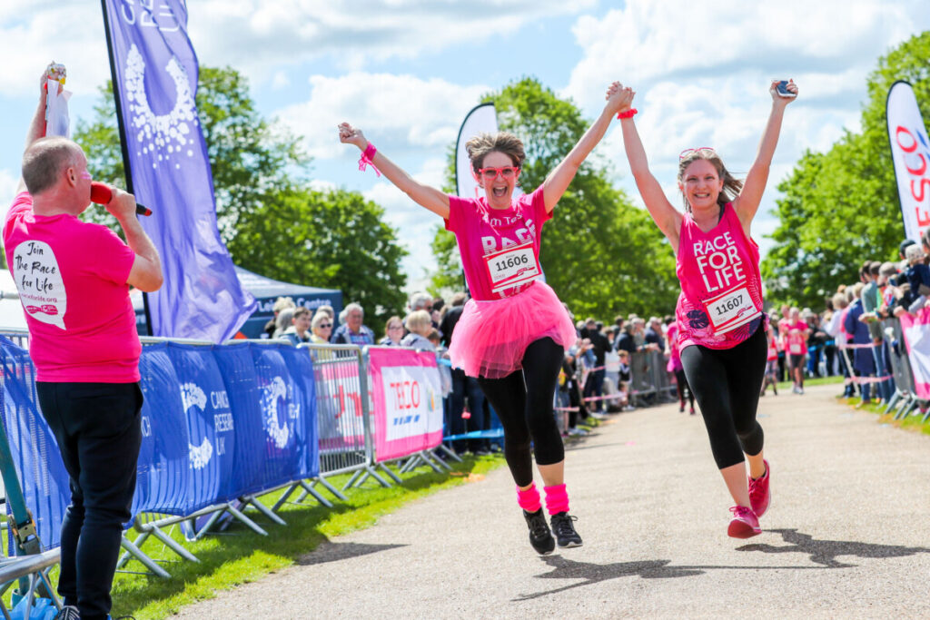 Two women cross the Race for Life finish line