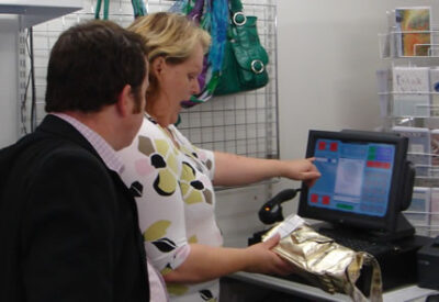 Man and woman at a British Red Cross shop till