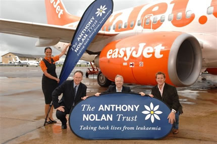 EasyJet staff with Anthony Nolan Trust banners beside an aircraft