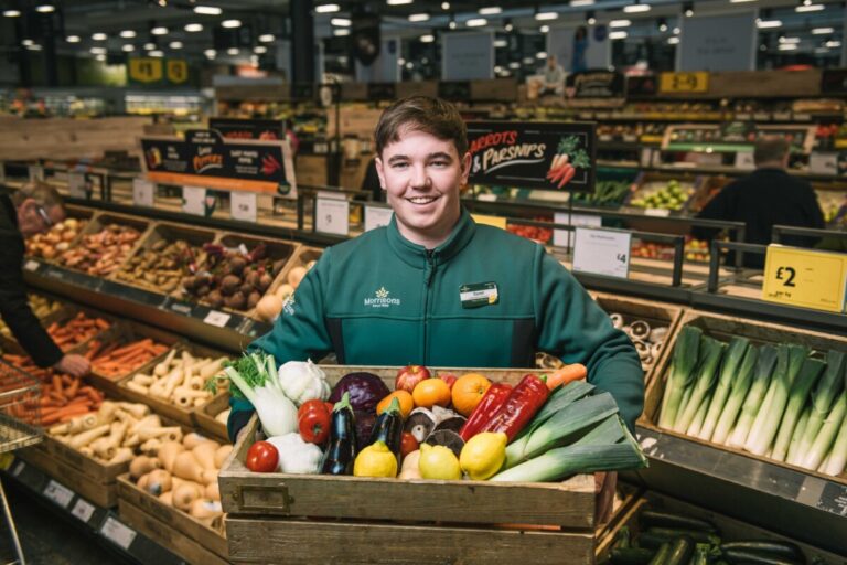 Morrison's staff member with fruit and vegetables. Photo: Morrisons