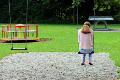 girl on a swing in a playground. Photo: Pixabay