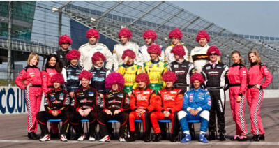 British Touring Car Championship teams with pink wigs on the race track