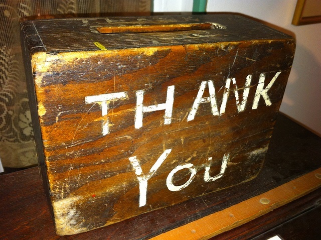 'Thank you' on the side of a heavy wooden donation box