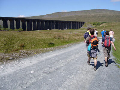 Walkers tackle the Three Peaks challenge, with long viaduct between hills to the left