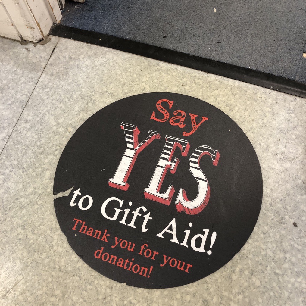 Say YES to Gift Aid. Sign on the floor in Salvation Army shop, Colchester. Photo: Howard Lake